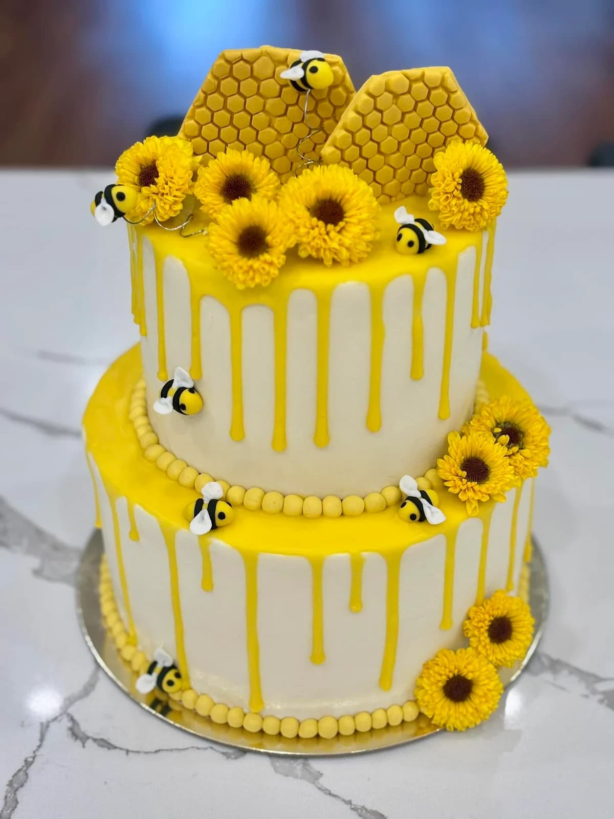Sweet Cake Factory two-tier vanilla buttercream cake with sunflowers, honeycomb and tiny fondant bees